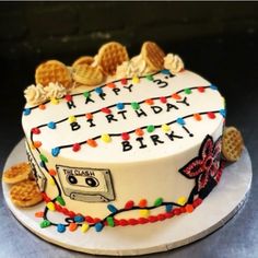 a birthday cake decorated with cookies and lights