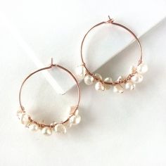 Pretty pearls and trendy rose gold are the perfect partners in these bohemian beauties!Handwrapped from genuine freshwater pearls and rose gold-filled wire. Earrings measure 1 inch/2.5 cm across.Giving as a gift? Gift wrap available here:https://www.etsy.com/listing/157310249/gift-wrap-add-on-to-any-stuff-and?ref=shop_home_feat_3 Rose Gold Pearl Jewelry With Wire Wrapped Detail, Wire Wrapped Rose Gold Hoop Jewelry, Rose Gold Wire Wrapped Hoop Jewelry, Adjustable Dangle Hoop Earrings In Rose Gold, Rose Gold Wire Wrapped Hoop Earrings, Rose Gold Dangle Hoop Earrings With Pearl Drop, Gold Bar Earrings Studs, Ruby Earrings Studs, Gold Bar Earrings