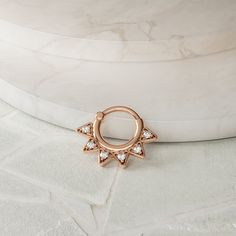 "Geometric with just the right amount of sparkle, this 14k rose gold genuine diamond helix hoop is truly unique and lots of fun to wear.  Materials: * 14k solid rose gold (Weight: 1.45g) * Genuine or lab grown white diamond (Weight: 0.07ct VS-SI/G-H) Measurements:      Inner diameter: 0.3\" - 8mm Outer diameter: 0.7\" - 18mm Wire thickness: 18g - 1mm Number of diamonds: 7 Diamond size: 1.3mm To keep your jewelry looking new, take a soft cloth or toothbrush with mild soap and gently brush/wipe th Rose Gold Internally Threaded Hoop Septum Ring, Rose Gold 14k Hoop Septum Ring, Internally Threaded Rose Gold Septum Ring, Hypoallergenic Rose Gold Hoop Septum Ring, Small Hoop Rose Gold Jewelry With Prong Setting, Small Hoop Rose Gold Jewelry With Diamond Accents, Rose Gold Diamond Cut Huggie Jewelry, Gold Cartilage Earrings, Helix Ring