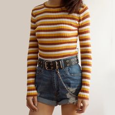 Long sleeved ribbed stripe shirt with mustard tones. Stretches to fit. One size fits S-M 25"-38" chest 21" length Retro Striped Ribbed Tops, Retro Ribbed Striped Tops, Trendy Vertical Stripes Tops For Fall, Casual Brown Tops With Striped Collar, Fitted Tops With Vertical Stripes For Fall, Fitted Vertical Stripes Top For Fall, Retro Mustard Long Sleeve Tops, Mustard Retro Long Sleeve Tops, Retro Striped Tops For Fall