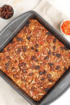 a pan filled with granola and raisins on top of a table