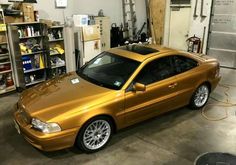 a gold car is parked in a garage