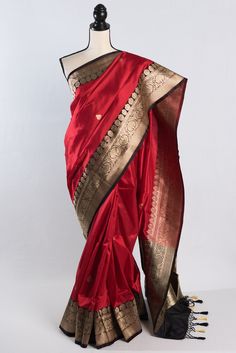 Introducing our stunning Silk Mark Certified Banarasi Silk Saree in a mesmerizing combination of red, black, and water gold zari. Handcrafted by skilled artisans, this saree boasts traditional Banarasi weaving techniques and timeless design. The luxurious silk fabric drapes effortlessly, while the intricate zari work adds a touch of elegance and opulence. Whether you're attending a wedding, a special occasion, or simply want to make a statement, this saree is sure to elevate your style. Embrace the heritage and craftsmanship of India with this exquisite Banarasi silk saree, a must-have addition to your ethnic wear collection. This is a SILK MARK CERTIFIED Saree. Color : Red, Black with Water Gold Zari Blouse Piece : Yes ( cut and separated from the saree ). Fall Pico : Yes.  Care: Dry-Clea Luxury Orange Katan Silk Saree, Luxury Katan Silk Saree With Weaving Work, Luxury Red Banarasi Silk Embroidered Fabric, Red Saree With Pallu For Traditional Ceremonies, Red Bollywood Art Silk Saree, Bollywood Style Red Art Silk Saree, Red Bollywood Style Art Silk Saree, Red Paithani Silk Traditional Wear With Cutdana, Fitted Red Tussar Silk Dupatta