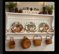 some baskets and plates are hanging on a shelf