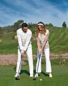 two people are playing golf on the green