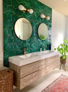 a bathroom with two sinks and mirrors on the wall