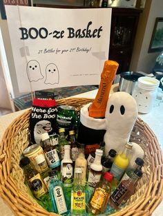 a basket filled with booze and bottles on top of a table next to a sign