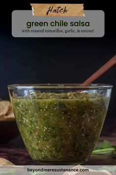 green chile salsa in a glass bowl with tortillas and pita chips on the side