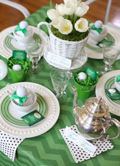 a table set for st patrick's day with green and white decor