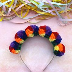 This multi- coloured headband is sure to get you noticed wherever you go! The six woollen pom poms are all the colours of the rainbow; red, orange, yellow, green, blue and purple. The diameter of each pom pom is: 3.5cm /1.5in and they have all been securely attached to a silver alice band.  I make every effort to accurately represent each product's colour but variances may occur due to differences in computer monitor/tablet/mobile device settings. I'm a sociable person, so come and find me on: Adjustable Fun Multicolor Hair Accessories, Playful Multicolor Hair Accessories With Matching Headband, Playful Multicolor Headband For Party, Whimsical Adjustable Multicolor Headband, Fun Multicolor Hair Accessories With Matching Headband, Multicolor Festival Hair Accessories With Matching Headband, Playful Multicolor Hair Accessories For Party, Whimsical Multicolor Hair Accessories With Matching Headband, Fun Multicolor Headband As Gift