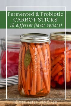 jars filled with carrots sitting on top of a wooden table