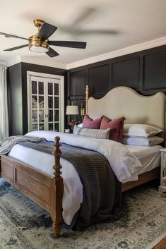 a bedroom with a large bed and ceiling fan