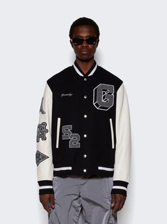 "Find GIVENCHY Varsity Jacket on Editorialist. Classic fit Sleeves in grained calfskin leather with embroidered patches on the right sleeve G, 52 patches and small GIVENCHY signature embroidered on the front4G embroidered patch on the back Ribbed elasticated knit collar, cuffs and hem with contrasting stripes Snap closure Two side pockets with contrasted piping Dimensions: Model is 6'1\"/185cm and is wearing a size EU48 Composition: 80% Wool, 20% Polyamide Care: Care according to label" Brand Ideas, Care Care, Embroidered Patch, Knit Collar, Embroidered Patches, Snap Closure, Piping, Givenchy, Calf Skin