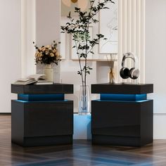 two black and blue side tables with flowers in vases