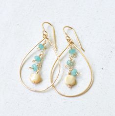 "These lovely gold teardrop earrings feature tiny aqua dyed jade and mother of pearl daintily hanging from a gold filled chain. Teardrops are made from hammered 18g gold filled wire & measure approximately 2\" in length." Gold Wire-wrapped Briolette Teardrop Earrings, Gold Wire Wrapped Briolette Teardrop Earrings, Handmade Gold Teardrop Earrings 14k Gold-filled, Handmade Gold Teardrop Earrings In 14k Gold-filled, Handmade Gold Teardrop Earrings In 14k Gold Filled, Dainty Teardrop Pearl Earrings For Jewelry Making, Dainty Teardrop Pearl Earrings Wire Wrapped, Dainty Teardrop Wire Wrapped Pearl Earrings, Gold Teardrop Earrings With Dangling Beads