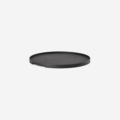 a black plate on a white background with no one in the room to see it