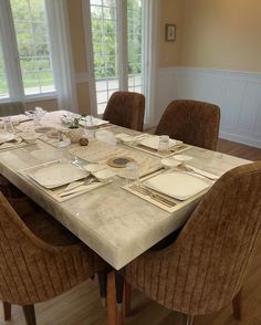 a dining room table set with place settings and place settings for the dinner guests to eat