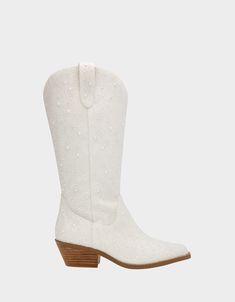 a pair of white cowboy boots with studdings on the side and wooden heel