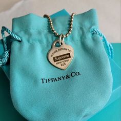 Authentic, Return To Supreme Heart Tag Necklace. Measures 24". Very Good Preowned Condition With Minimal Surface Wear. Comes With Brand New Tiffany Pouch And Box. Heart Pendant Jewelry With Logo Charm As Gift, Heart Pendant Jewelry With Logo Charm For Gifts, Designer Silver Jewelry With Heart Charm, Tiffany Tag Necklace, Luxury Silver Heart Necklace With Heart Charm, Sterling Silver Necklace With Logo Charm, Tiffany Necklace Y2k, Tiffany Two Heart Necklace, Tiffany Heart Tag Necklace