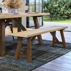 a wooden table with two benches in front of it and an open window behind it