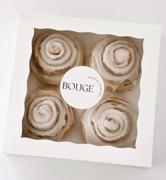 four pastries in a white box with a label that says bouge on it