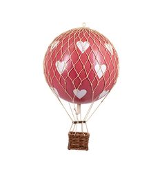 a hot air balloon with hearts painted on it's front and sides, attached to a wicker basket