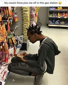 a woman sitting on a bench in a store looking at her cell phone while she shops