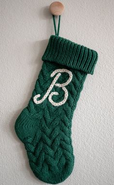 a green knitted stocking hanging on the wall