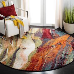 a colorful rug in the corner of a room with a chair and potted plant