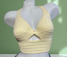 Turn heads and radiate confidence in this exclusive crochet crop top. Handcrafted for a look as unique as you are! This crop is crafted from a luxurious 50% cotton and 50% acrylic blend, offering both the natural breathability of cotton & the soft, comfortable feel of acrylic. Perfect for soaking up the sun in comfort!  ---------CARE-------- For the gentlest care, hand wash it with cool water only and lay it flat to dry. Alternatively, you can machine wash on a gentle cycle with cool water, but Handmade Summer Crochet Halter Neck Top, Handmade Halter Neck Crochet Top For Summer, Handmade Bohemian Crochet Crop Top, Fitted Cropped Summer Crochet Top, Bohemian Cropped Crochet Top, Fitted Cropped Crochet Summer Top, Handmade Crochet Crop Top For Festival, Handmade Cropped Crochet Top For Festival, Fitted Cropped Crochet Top For Summer