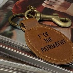 leather keychain with the words f k the patriarchy on it