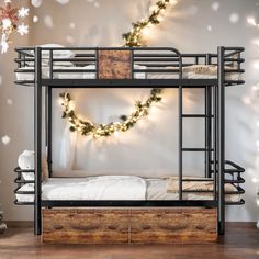 the bunk bed is decorated with christmas lights