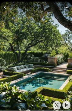 an outdoor pool surrounded by hedges and trees in the middle of a garden with seating areas