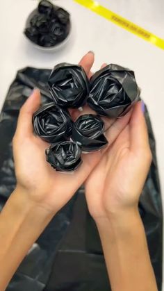 a person holding some black objects in their hands