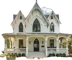 a large white house with two story windows and a front porch on the second floor