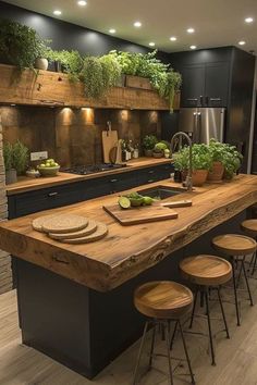 a kitchen with an island and wooden stools in front of the counter top that has potted plants on it