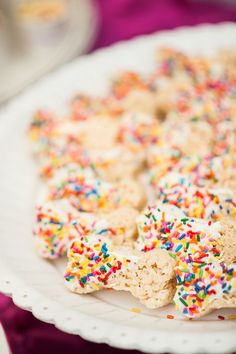 a plate full of cookies with sprinkles on it