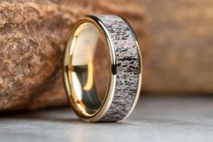 a wedding ring with antler wood inlays the center and gold plated edges