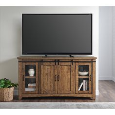 a flat screen tv sitting on top of a wooden cabinet