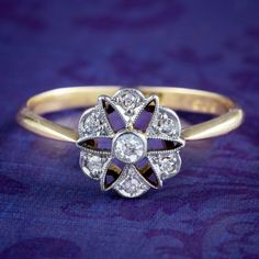 an antique diamond ring on a purple background