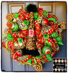 a leopard print wreath with red and green decorations