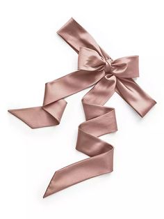 the pink satin ribbon is tied in three different directions and has a bow on top