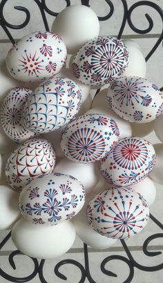 some white eggs with red, white and blue designs on them