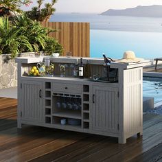 the outdoor kitchen is built into the deck by the pool and has an island style counter top