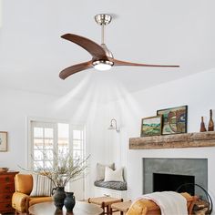 a living room with a ceiling fan in it's center and a fire place