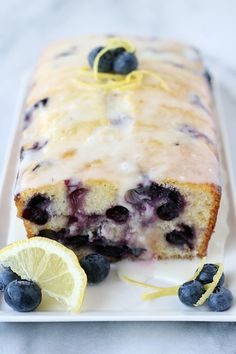 a cake with blueberries and lemon on it