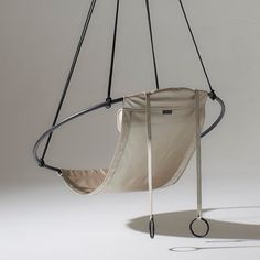 a swing chair hanging from a metal frame