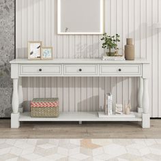 a white console table with two drawers and a mirror on the top, against a striped wallpapered background