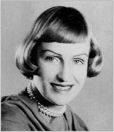 an old black and white photo of a woman with her hair in a bobble