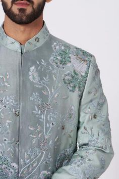 Ice blue sherwani highlighted with tone-on-tone embroidery, inside-out placket and full sleeves. Comes with kurta, churidar and chateau grey stole.
Components:4
Embroidered
Neckline:Band Collar
Sleeve Length:Full
Fabric:Slub Silk
Color:Blue
Concealed placket
Pintucks kurta
Button placket on the shoulder
Asymmetric hem
Single button at the waist
Embroidered stole - Aza Fashions Formal Semi-stitched Embroidered Sherwani, Embroidered Semi-stitched Art Silk Sherwani, Festival Semi-stitched Sherwani With Cutdana, Ceremonial Long Sleeve Semi-stitched Sherwani, Semi-stitched Blue Sherwani With Cutdana, Blue Sherwani, Nehru Jackets, Embroidered Neckline, Band Collar